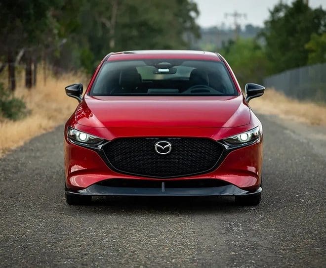 NCPS - New Car Procurement Specialists A red car is driving down the street